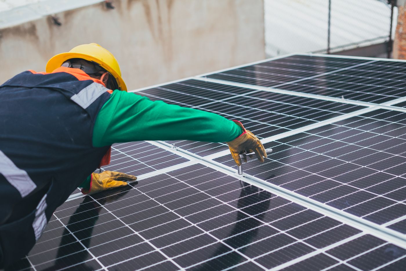 Technician installing commercial solar panels